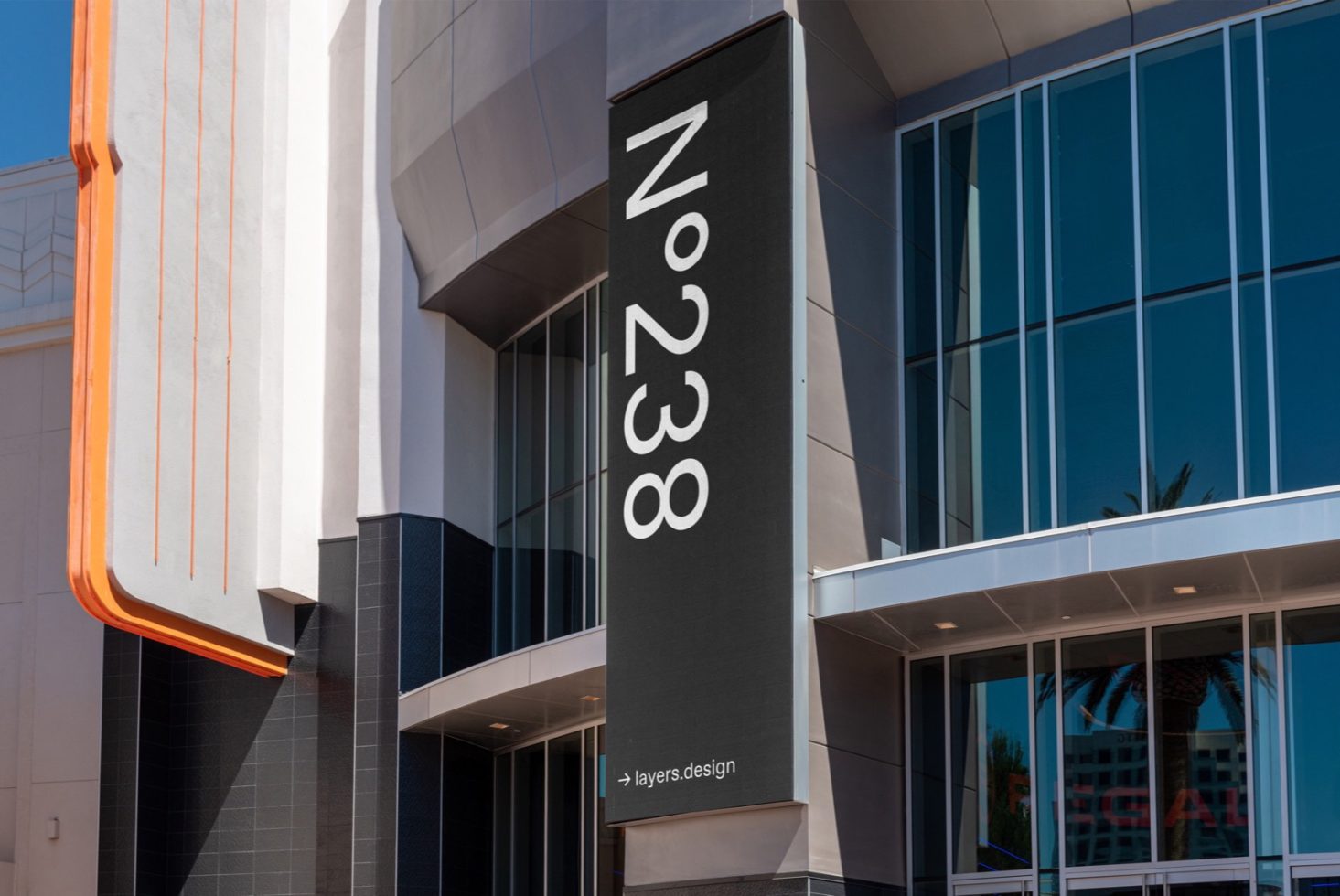 Modern building facade featuring a large vertical number signage design, architectural details, and clear blue sky, ideal for mockup or graphics.