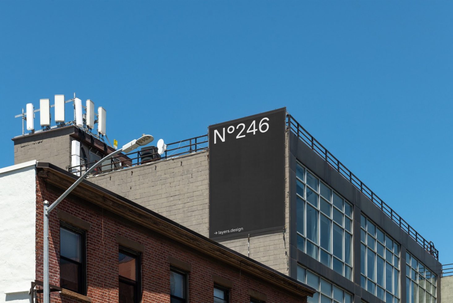 Urban billboard mockup on building facade with clear sky, ideal for graphic designers to showcase advertising designs, billboard marketing, modern mockup.