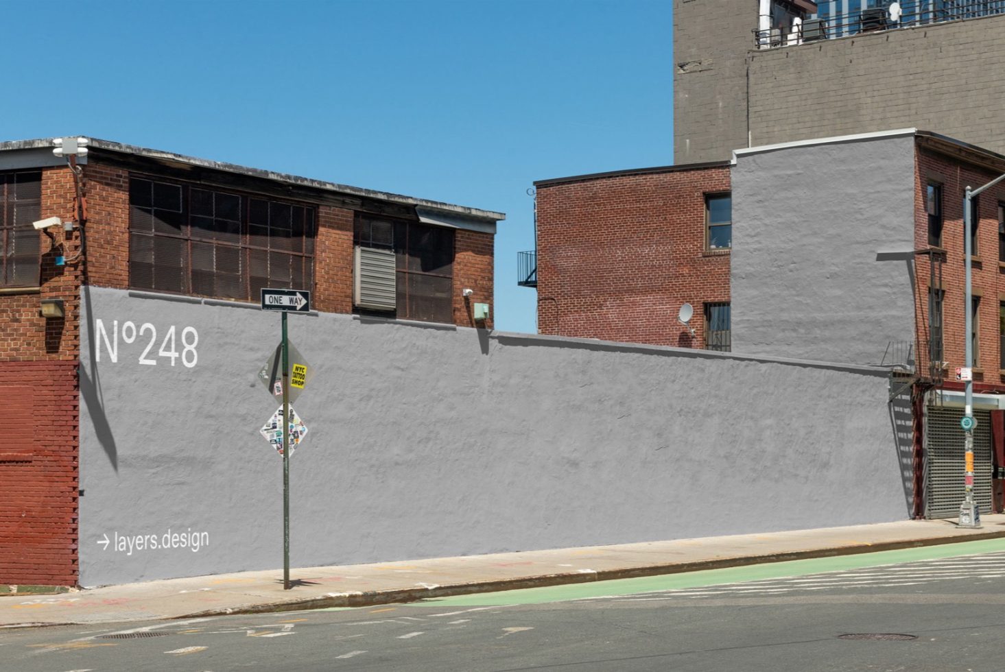 Urban street corner with clear wall space for mockup, ideal for showcasing outdoor advertising or mural designs to clients.