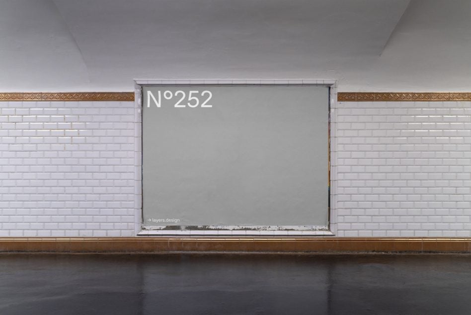 Horizontal storefront window on white brick with gold trim details