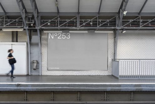 Billboard mockup at a subway station platform with a blurred passerby for urban advertising and marketing presentations.