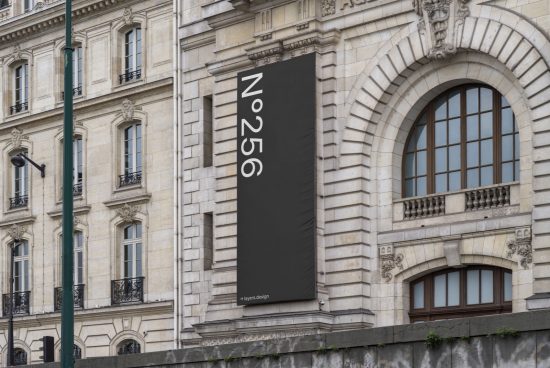 Vertical banner mockup on elegant building facade, showcasing minimalist design and typography for outdoor advertising by designers.
