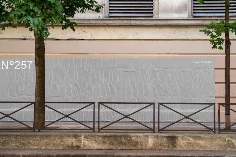 Urban outdoor billboard mockup on a gray wall with tree and railing, realistic street advertising canvas for designers graphics.