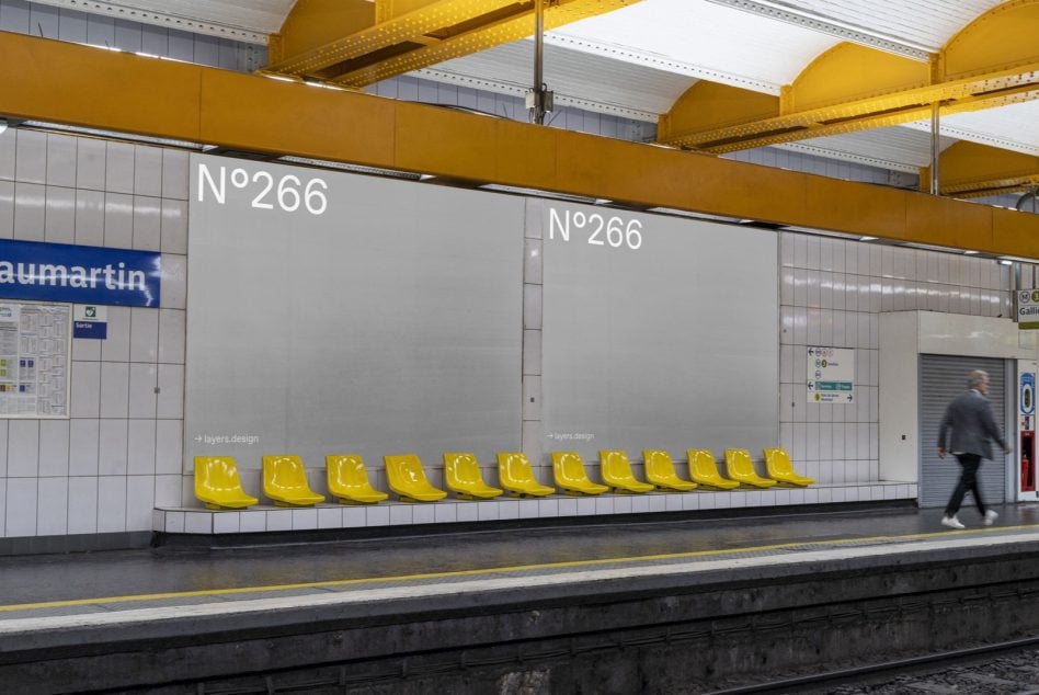 Light gray billboard mockup with yellow seating in bright station