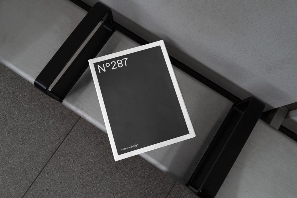 Elegant magazine mockup on modern metal bench, sleek design presentation, urban setting, essential for branding, clean layout.