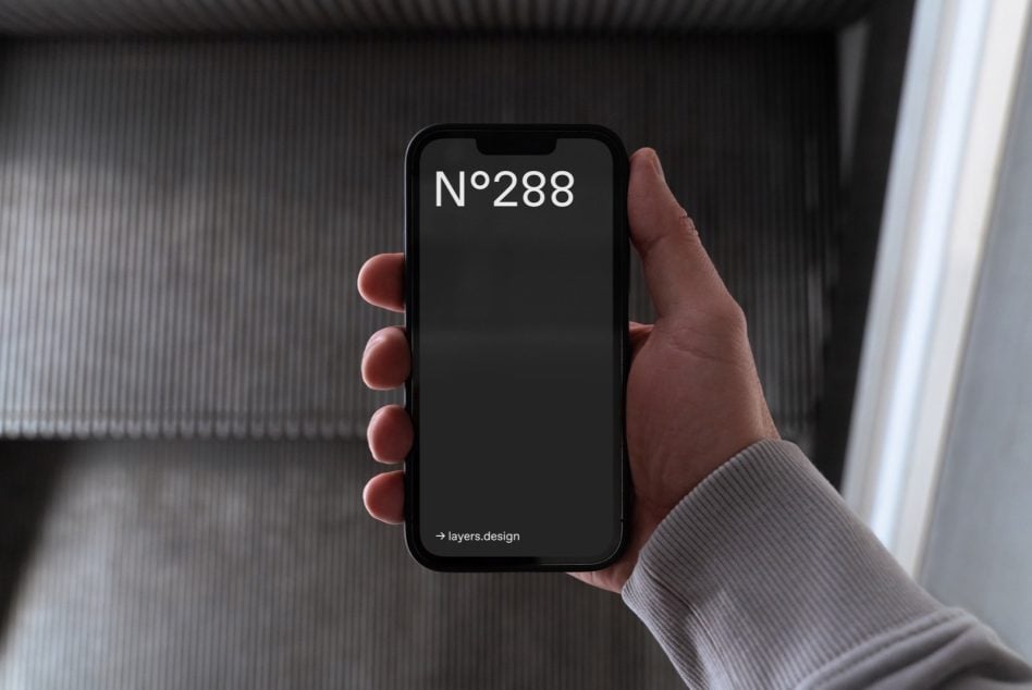 Black smartphone in hand showing N°288 text on dark screen