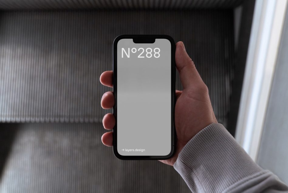Hand holding black smartphone with blank screen display