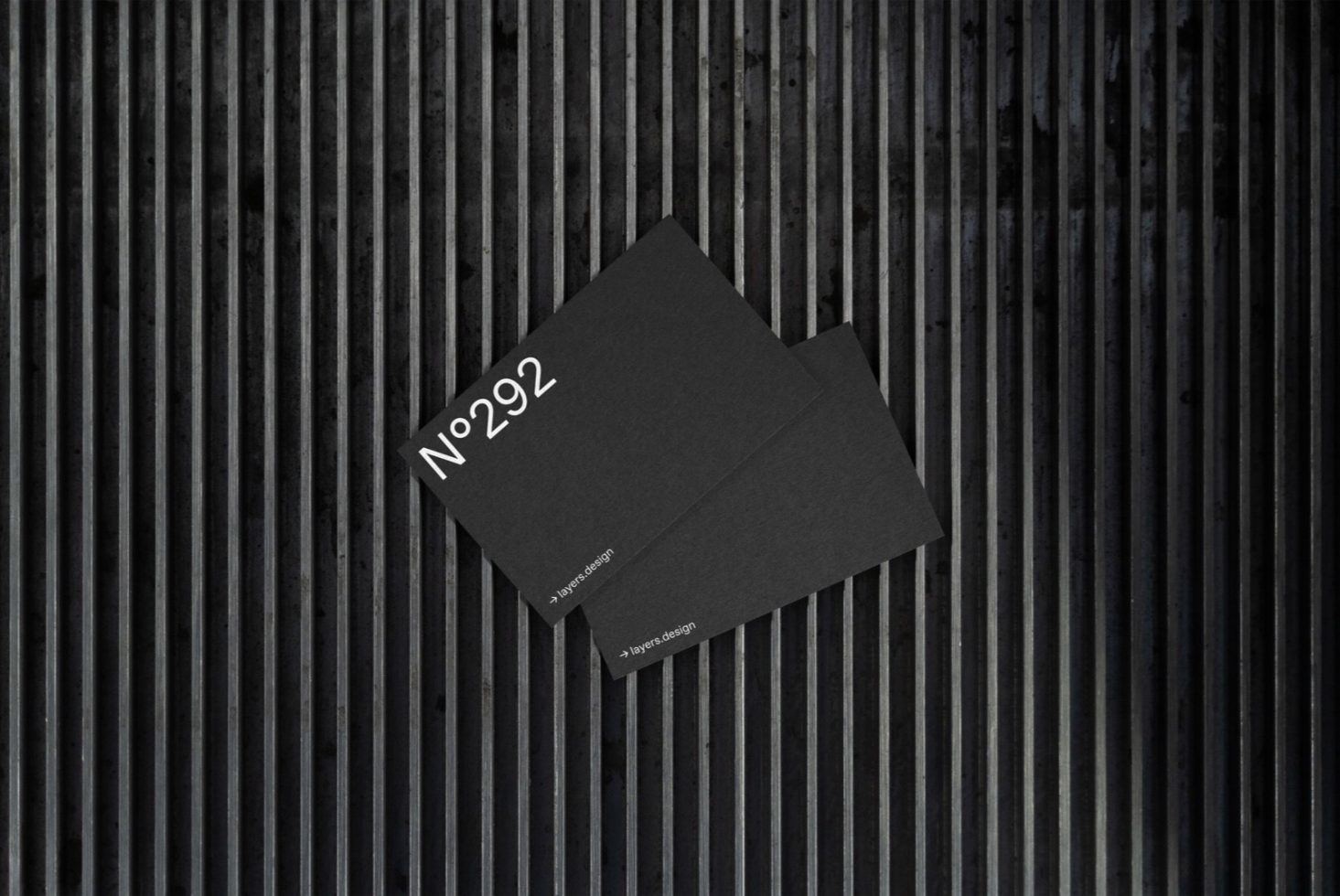 Elegant black business cards with minimalistic design on textured background, ideal for mockup graphics, professional branding materials.