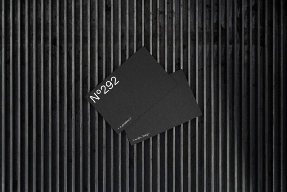 Black business card mockup angled on striped metal surface