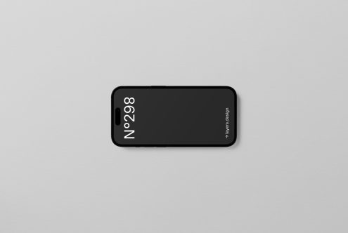 Smartphone mockup lying on a plain surface with modern, minimalistic style, ideal for showcasing mobile app and UI designs.