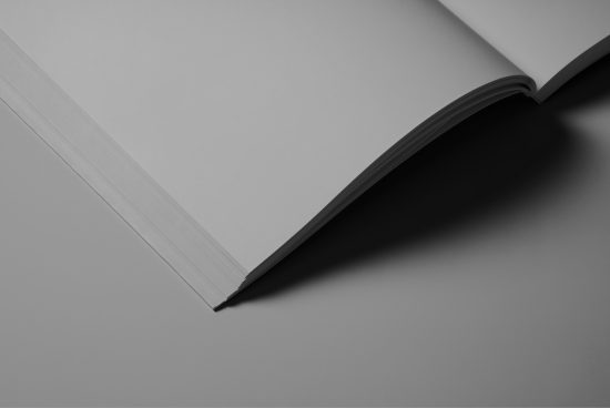 Open hardcover book mockup on a plain background, ideal for designers to present artwork and fonts in a clean, minimalist setting.