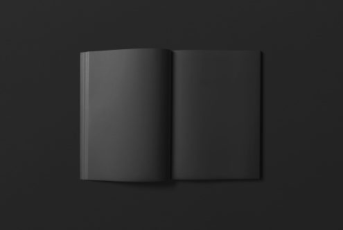 Black magazine mockup with open pages on dark background, isolated for design presentation and portfolio showcase.