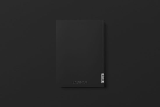 Black book cover mockup on dark background, minimalist design, blank space for branding, template ready for presentation.