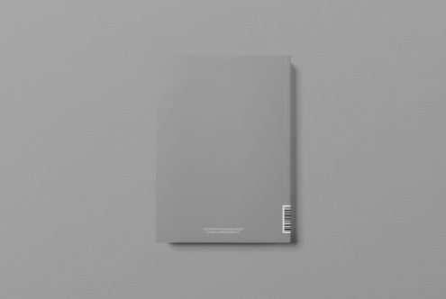 Minimalist magazine mockup with blank cover and barcode on grey background, perfect for editorial design presentations.