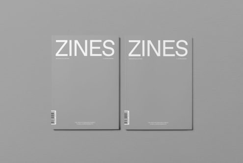 Magazine mockup with two minimal design zines on a gray background, showcasing editable cover for presentation and portfolio display.