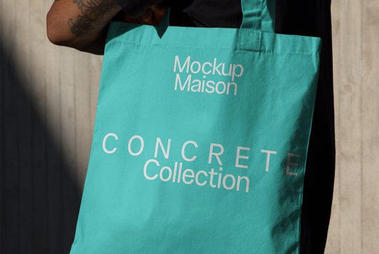 Person holding a teal tote bag mockup with Mockup Maison text, ideal for graphic design presentations and eco-friendly branding.