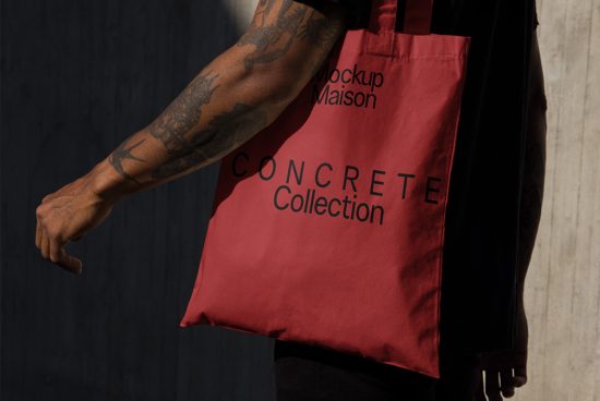 Person holding a red tote bag mockup with black text design, ideal for branding presentations and graphic design assets.