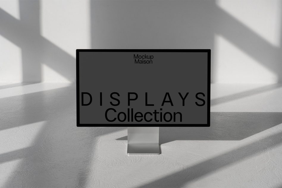 Desktop monitor on white surface with dramatic window light casting shadows