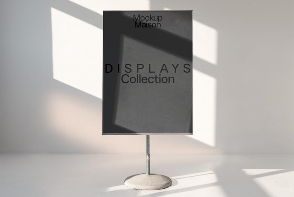 Vertical display stand mockup with black screen on concrete base, sunlight casting shadows