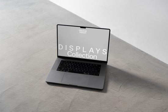 Laptop on concrete background with screen mockup design for digital asset display, perfect for designers seeking realistic mockups.