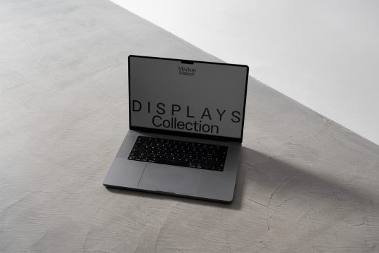 Laptop mockup on a concrete background displaying a screen with text, ideal for showcasing designs and digital assets for creative professionals.