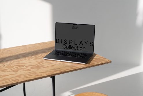 Laptop with screen mockup on wooden table, modern design, for showcasing website graphics, templates for digital assets, minimalist style.