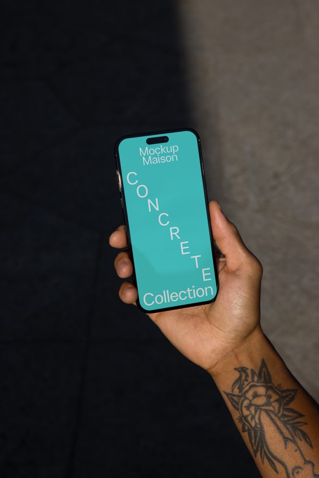 Smartphone mockup in hand displaying teal screen with text layout for designers, ideal for presentations and digital design showcases.