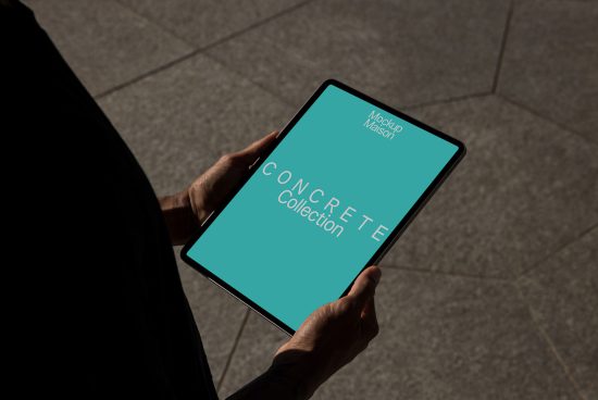 Person holding tablet displaying design mockup with text CONCRETE collection, for digital asset marketplace in mockups category.