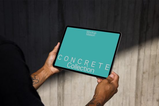 Person holding tablet with mockup design screen digital asset for designers featuring a bold Concrete Collection text in modern font, wood floor and wall background.