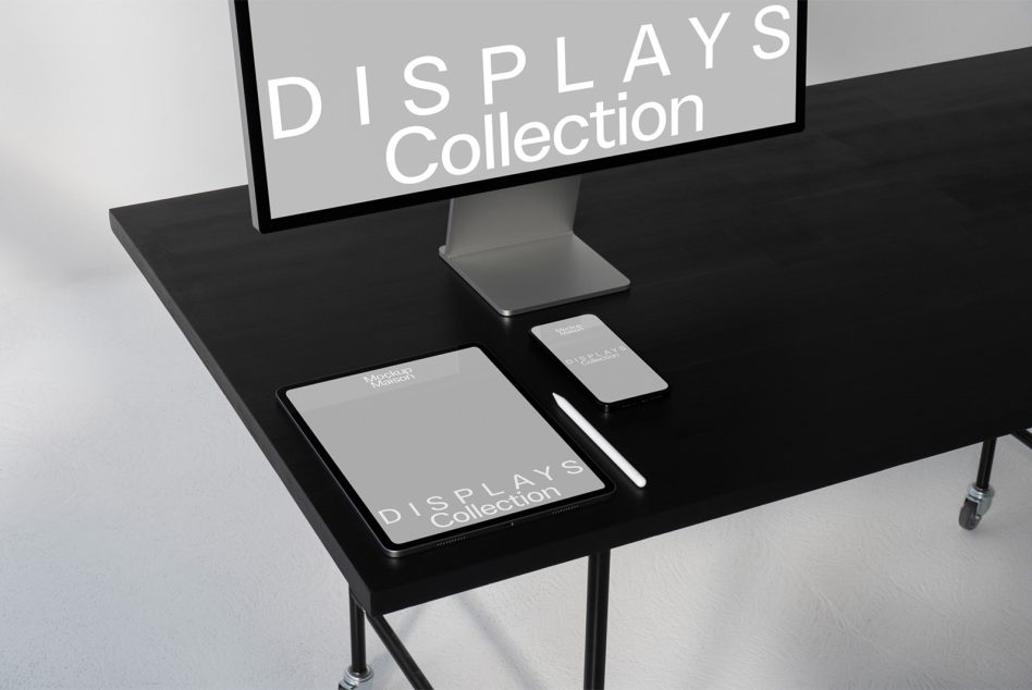 Desktop, tablet, phone mockups arranged on black table with monitor displaying text