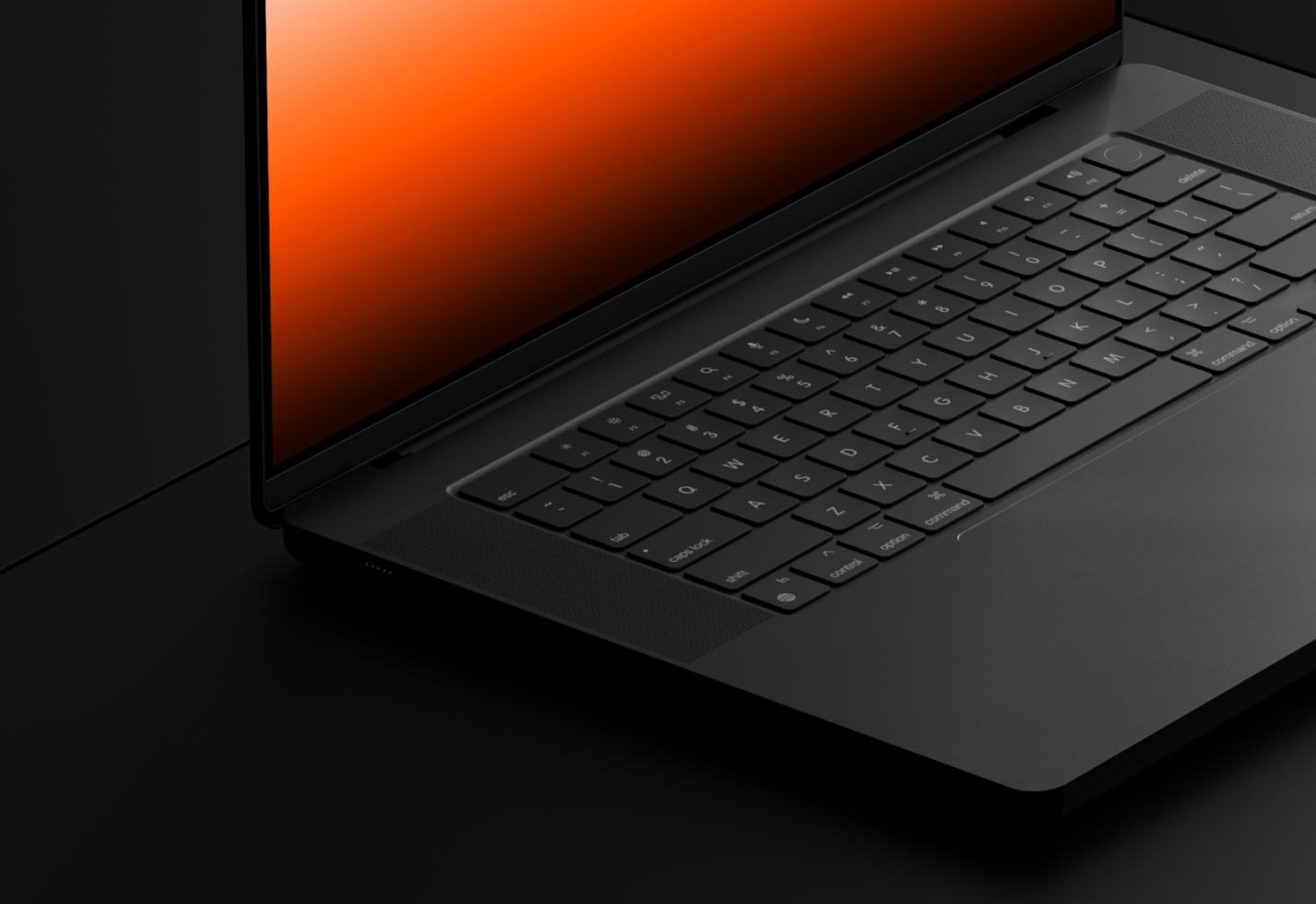 Laptop with orange screen on black surface for device mockup template, ideal for designer presentations and digital portfolios.