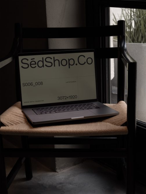Laptop screen mockup on wooden chair with SedShop branding
