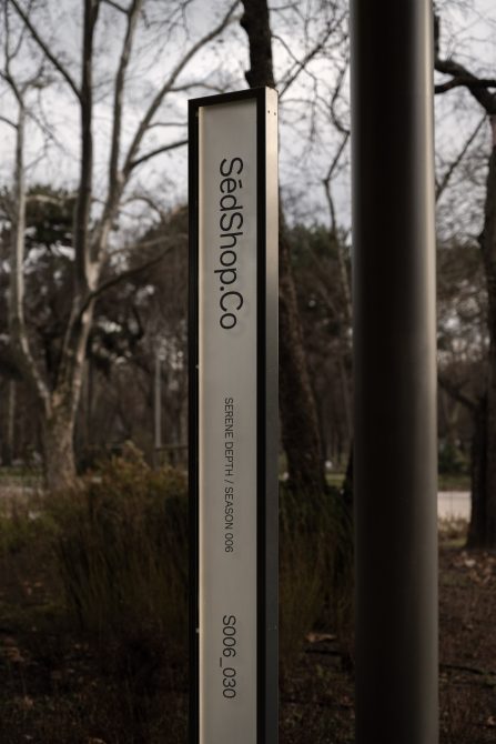 Vertical signage mockup in a park setting with clear typography, suitable for branding presentations and graphic design assets.