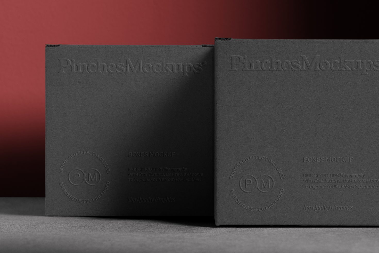 Black embossed product boxes mockup with subtle textures against a red background, ideal for branding and packaging design presentations.