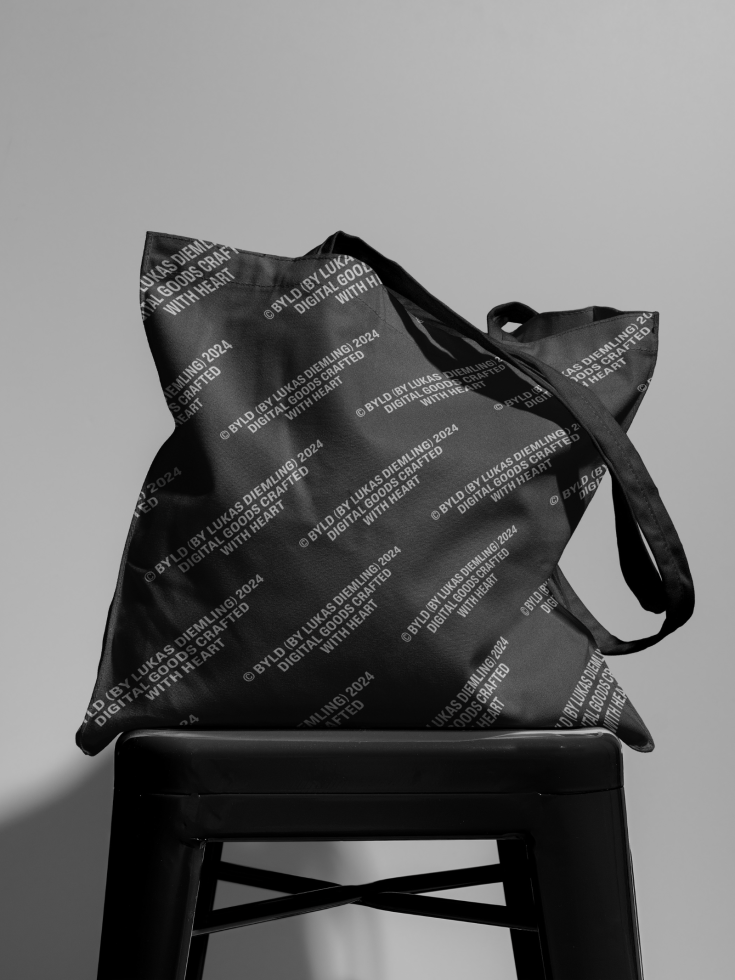 Elegant black tote bag with text pattern design on chair for graphic mockup, professional presentation, trendy accessory design, monochrome.