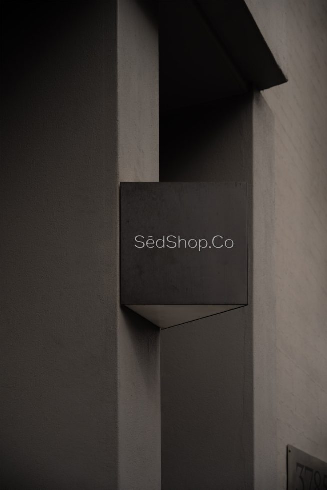 Elegant signage mockup on building facade for logo presentation, dark-themed signboard for designers and branding experts.