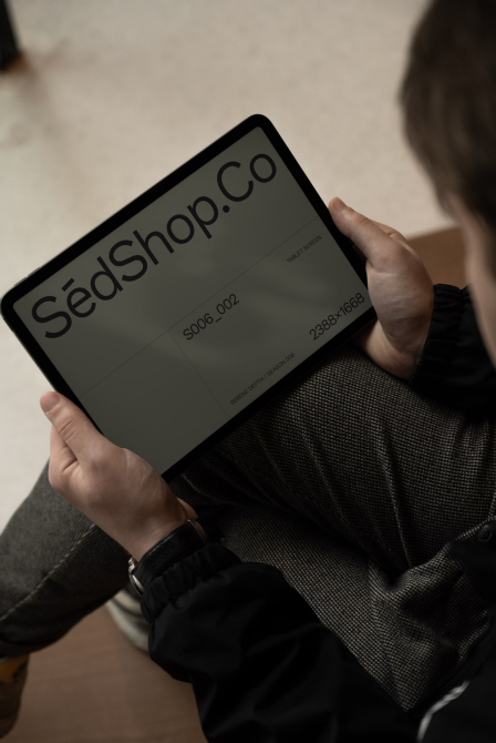 Person holding a tablet showcasing a design, ideal for mockup category, features minimalist web template screen, perfect for digital asset designers.