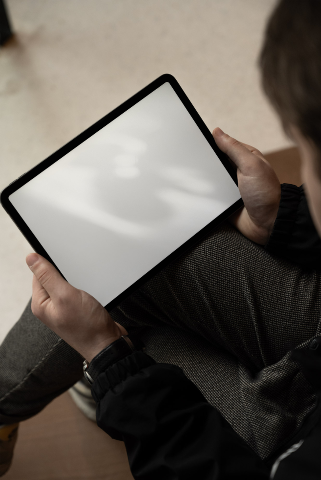 Person holding a blank screen tablet mockup with a clear view suitable for designers to showcase app and web designs.