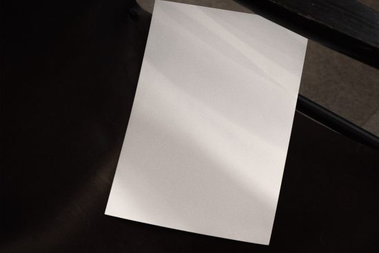 Blank A4 paper mockup on a dark surface for presentation of designs, stationery templates, and text layouts with a realistic shadow effect.