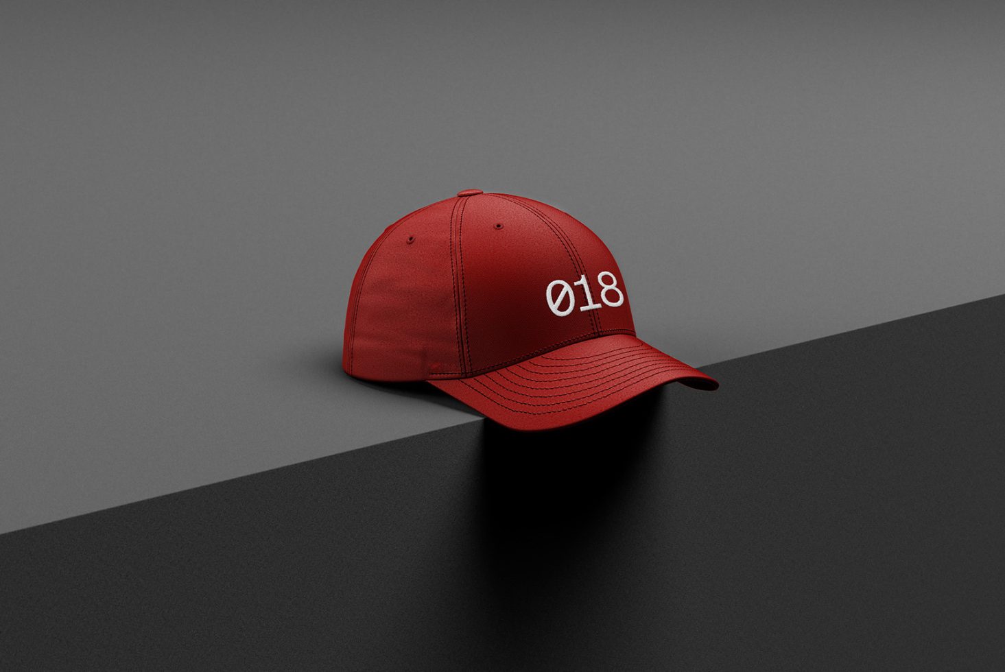 Red baseball cap mockup on a two-tone background, perfect for showcasing design work in apparel mockups category for designers.