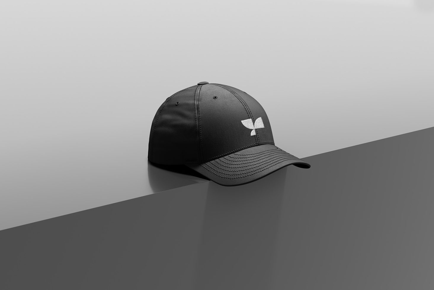 Black baseball cap with white logo on reflective surface for mockup template, sleek design, fashion accessory, product display.