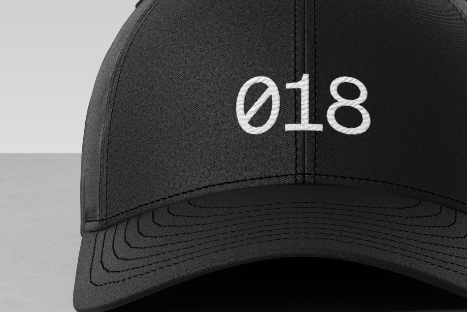 Close-up of a black baseball cap with white embroidery mockup, ideal for branding designs, fashion, and textile projects.