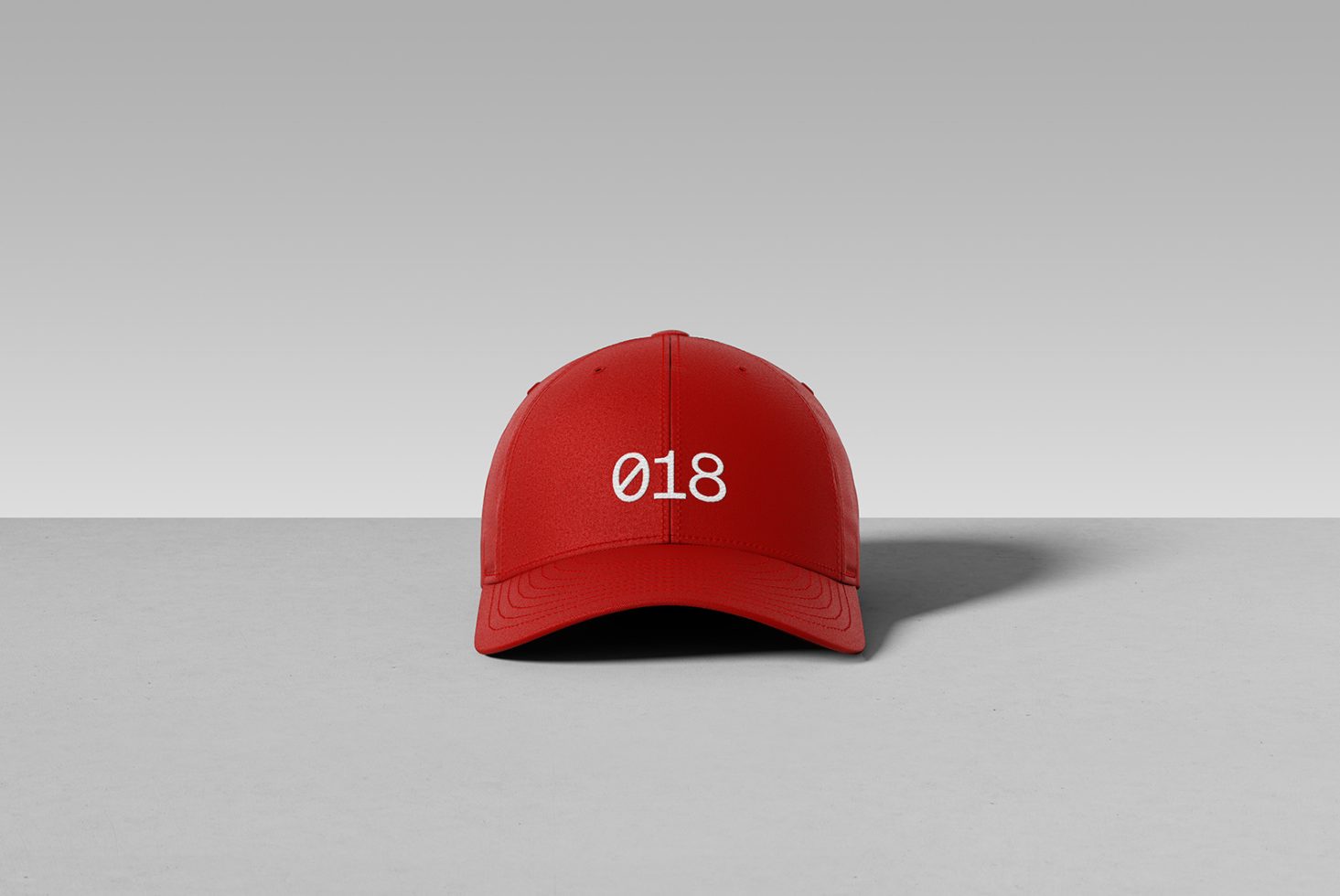 Red baseball cap front view on a neutral background, perfect for product mockups or design templates, showcasing clean lines and minimalist style.