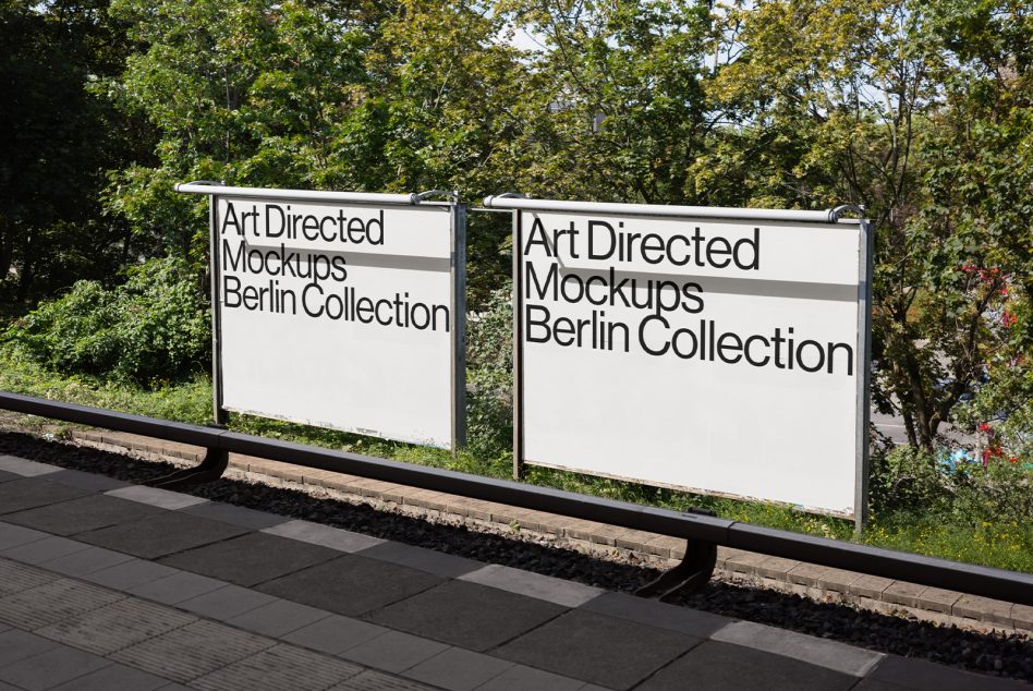 Two white billboard frames side by side with black text against green foliage