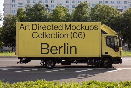 Yellow truck with Art Directed Mockups Collection Berlin text parked on street. Cityscape background. Graphic assets for designers. Mockup template for digital design.