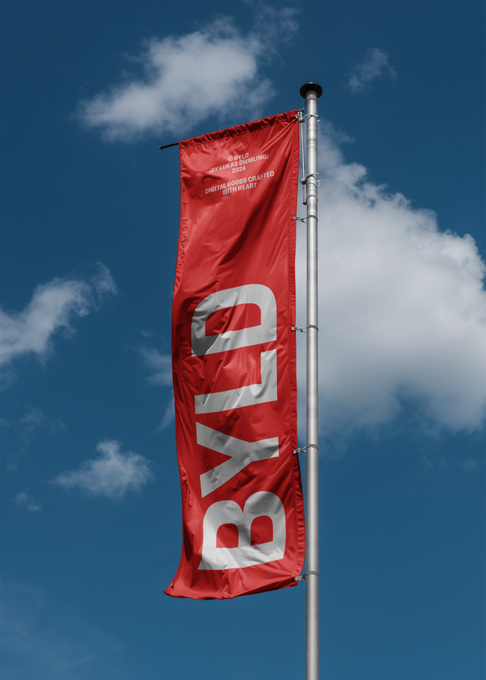 Red vertical banner flag mockup with white BYLD text against blue sky, ideal for designers creating branding templates, signage graphics, and outdoor visuals.