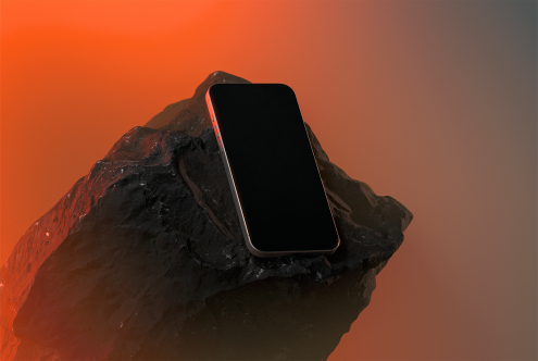 Smartphone mockup featuring a sleek black phone resting on a rugged rock with a vibrant orange background. Ideal for showcasing UI/UX designs.