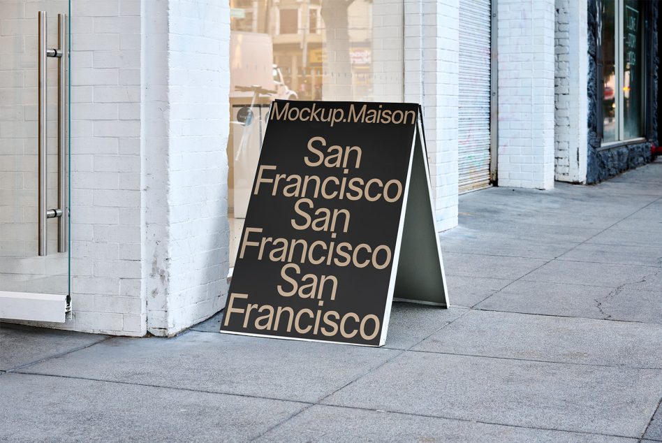 Black A-frame sidewalk sign with beige text showing San Francisco repeated vertically