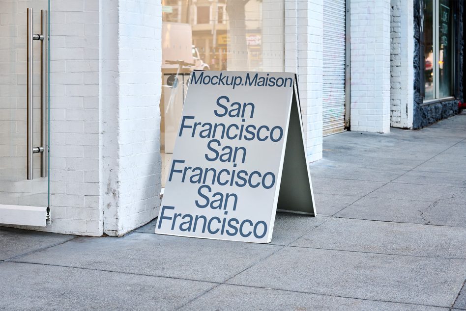 White A-frame sidewalk sign with navy text showing San Francisco repeated vertically
