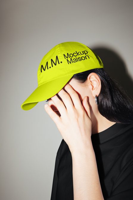 Person wearing neon green cap mockup with customizable logo for designers, ideal for creating branding and fashion accessories.